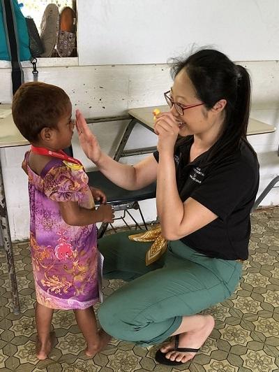 索菲娅Y. 方, MD, 马斯, examines a child during a Moran Eye Center Global Outreach eye care clinic in Micronesia in the spring.